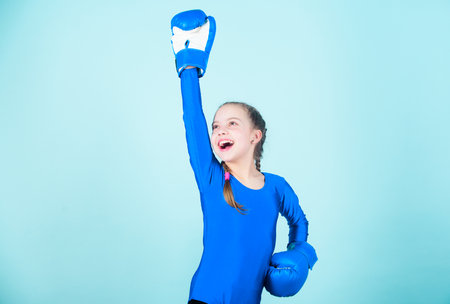 Always in good shape. Sport success. sportswear fashion. workout of small girl boxer. punching knockout. Childhood activity. Fitness diet. energy health. Happy child sportsman in boxing glovesの写真素材