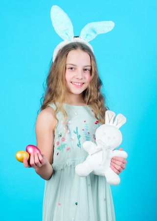 Holiday bunny girl with long bunny ears. Child cute bunny costume. Happy easter. Playful baby celebrate easter. Spring holiday. Happy childhood. Ready for Easter day. Easter activities for childrenの写真素材