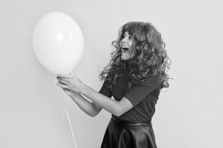 happy girl with party balloon on yellow background. wowの写真素材