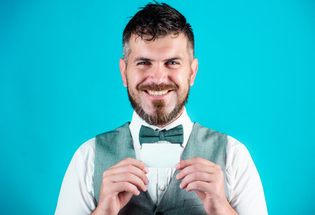 A business card as unique as you. Bearded man holding business card. Empty card for your contact information. Happy businessman smiling with bank card. Hipster with credit card, copy spaceの写真素材