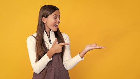 surprised girl with long hair on yellow background.の写真素材