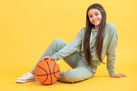 happy teen basketball girl in studio. teen basketball girl on background.の写真素材