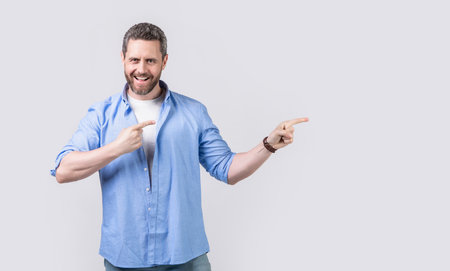 glad man pointing and offer advertisement in studio. photo of man pointing and offerの写真素材