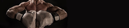 boxing sport advertisement with copy space. boxer in boxing sportswear isolated on black background.の写真素材