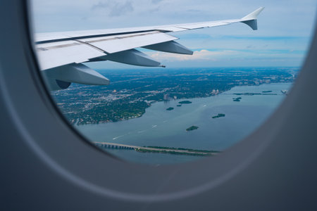 View from porthole. Aircraft window or porthole. Aircraft wing seen through porthole. Plane portholeの写真素材