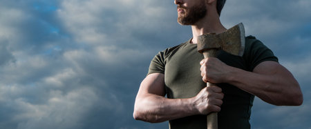 strong man with axe. caucasian man hold ax. brutal man on sky background. cropped viewの写真素材