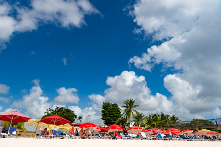 Bridgetown, Barbados - December 12, 2015: deckchair with people on beach at summer vacationのeditorial素材
