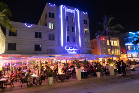 Miami, Florida USA - April 16, 2021: Miami south beach ocean driveilluminated buildings in night miami city with restaurant. beacon hotelのeditorial素材
