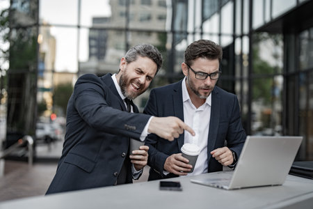 glad trader men freelancing online outdoor. trader business men freelancing online with laptop.の写真素材