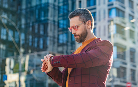 photo of punctual man check time on hand watch. punctual man in jacket check time