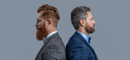 profile of men in tux on background. photo of men in tux suits. men in tux isolated on grey.