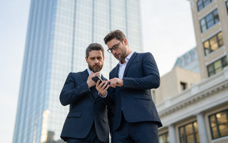 trader men freelancing online outdoor. trader business men freelancing online with phone.の写真素材