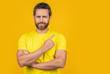 man pointing finger at advertisement offer. man pointing at advertisement offer in studio.の写真素材