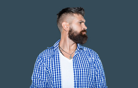 profile of bearded man wear checkered shirt on grey backgroundの写真素材