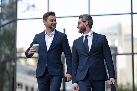 smiling business partners in suit negotiate at coffee break. photo of business partnersの写真素材