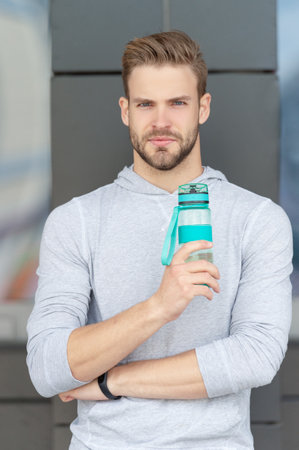 thirsty sportsman with water. thirsty sportsman with water bottle. thirsty sportsman
