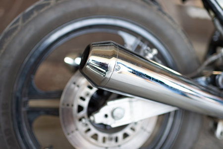 Kyiv, Ukraine - September 13, 2014: metal chrome muffler of Harley Davidson custombike