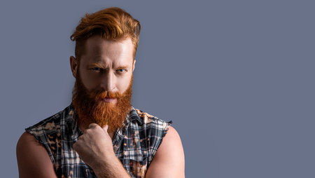 photo of brutal bearded guy with beard, advertisement. brutal bearded guy isolated on greyの写真素材
