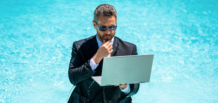 pondering business manager work in summer. business manager work in summer at swimming pool.