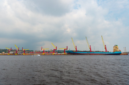 Manaus, Brazil - December 04, 2015: Mercosul line cargo barge in port with cranesのeditorial素材