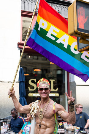 NEW YORK, NY, US - June 25, 2023: Pride march parade 2023 in New York. man gay with pride rainbow lgbtq flag peace. lgbt and lgbtq parade.のeditorial素材