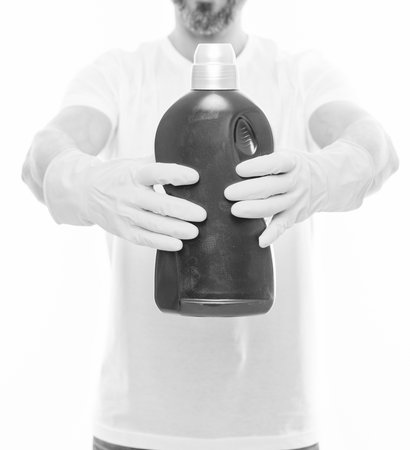 closeup of man with laundry detergent in studio. man with laundry detergent on background. photo of...