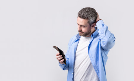 confused bankrupt man with wallet at hand. photo of bankrupt man with wallet.