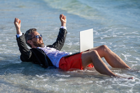 Businessman dreams on summer business in sea. Unwind through travel. Businessman relaxing at the...