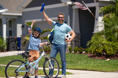 father and son navigate the path together. Quality time on bicycles. Father and son enjoying a ride together. hispanic father guiding son first bike ride. Father and son sharing biking adventureの写真素材