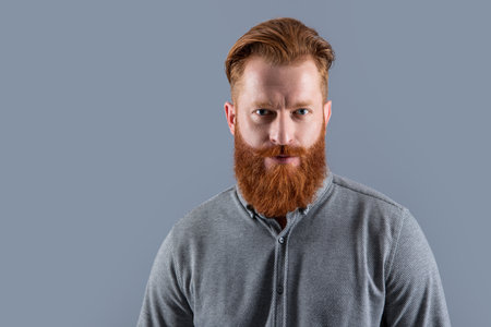 beard care. handsome unshaven man has beard, copy space. unshaven man with long beardの写真素材