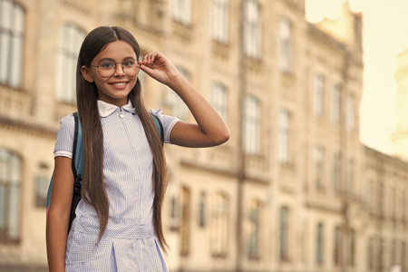 eyesight of cheerful school brunette girl. eyesight of school girl with glasses.の写真素材