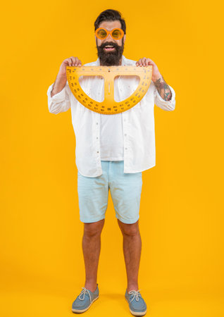 positive man hold geometry protractor isolated on yellow. man hold geometry protractor