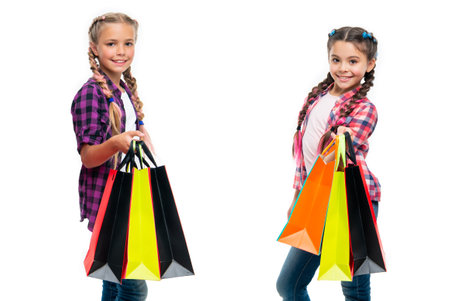girls with shopping bags. shopping sale and discount. teen children girls with bags. teen children go shopping. girls discover new fashion inspirationの写真素材