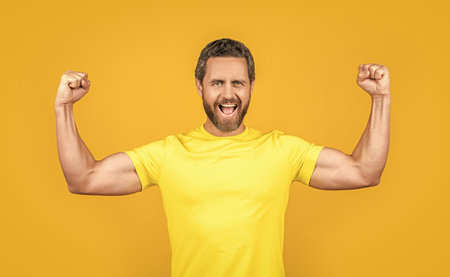 photo of happy man wear tshirt. happy man wear tshirt isolated on yellow.
