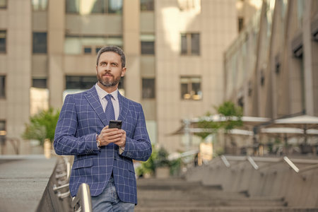 businessman messaging on phone outdoor, copy space. businessman messaging on phoneの写真素材