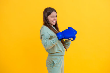 teen defense. girl sport training. sport active wear. Teen boxer training with determination. teen girl in boxing goves. boxing training of teen girl. girl learn punching. boxing exerciseの写真素材