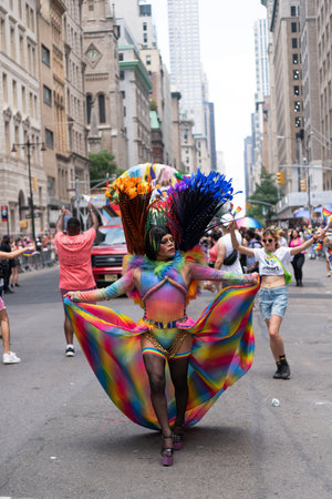 NEW YORK, NY, US - June 25, 2023: Pride march parade 2023 in New York. man gay with pride rainbow lgbtq flag peace. lgbt and lgbtq parade.のeditorial素材