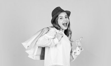 Spring shopping. Individual style. Girl wear hat blue background. Accessories shop. Fancy girl shopping. Shopping tour sales season. Black and white. Summer accessory collection. Fashion accessory. Child wear hat.の写真素材