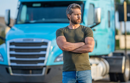 Semi trucks vehicle. Trucking owner. hispanic man posing in front of truck. Semi trucks vehicle. man driver near truck. Man owner truck driver near truck. man driver near lorry. trucker taking prideの写真素材