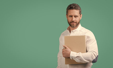 businessman freelancer holding laptop, banner. businessman freelancer isolated on blueの写真素材