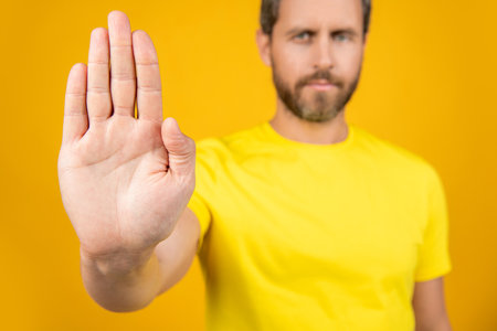 selective focus of man show stop rejection. man show stop rejection isolated on yellow.の写真素材