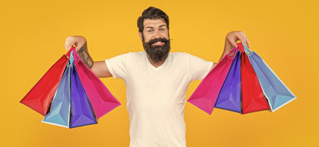 happy shopping man in studio. shopping man on background. photo of shopping manの写真素材