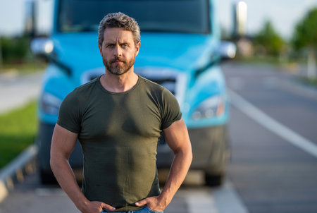 Trucking owner. Transportation vehicles. hispanic man posing in front of truck. Semi trucks vehicle....