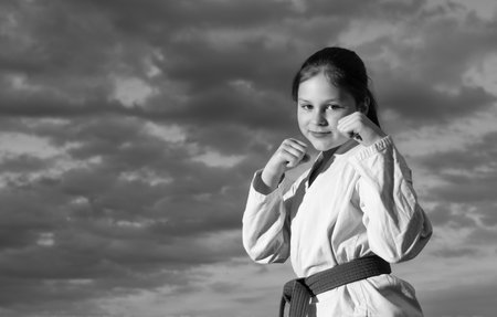 jujitsu girl in kimono on sky background.の写真素材