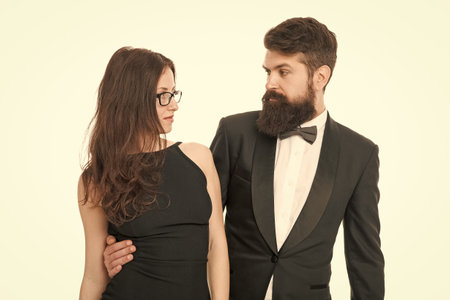Always protecting her. business partnership. love and romance. formal couple celebrate special occasion. valentines day concept. elegant formal fashion. sexy woman and tuxedo man. couple in loveの写真素材