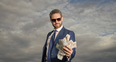 richness of man in glasses with money in suit. richness photo of man with money. richness of man...