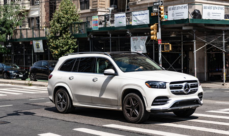 New York City, USA - August 05, 2023: Mercedes-Benz GLS580 4MATIC SUV white car front and passenger side view, circulating through avenue, no tagのeditorial素材