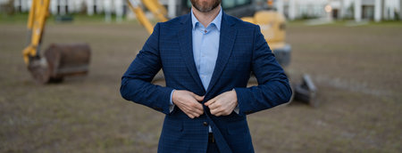 cropped view of construction business owner in suit. construction business owner at site.の写真素材