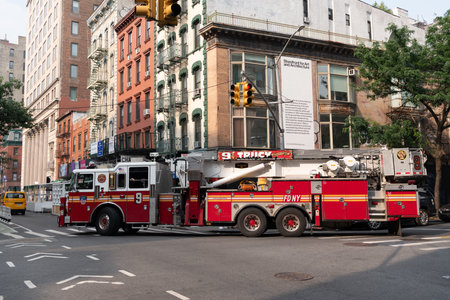 Jersey City, USA - June 30, 2023: firetruck truck Fire Department turning a corner side viewのeditorial素材