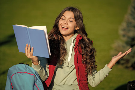happy school teen girl read outdoor. school teen girl read outside. school teen girl read book.
